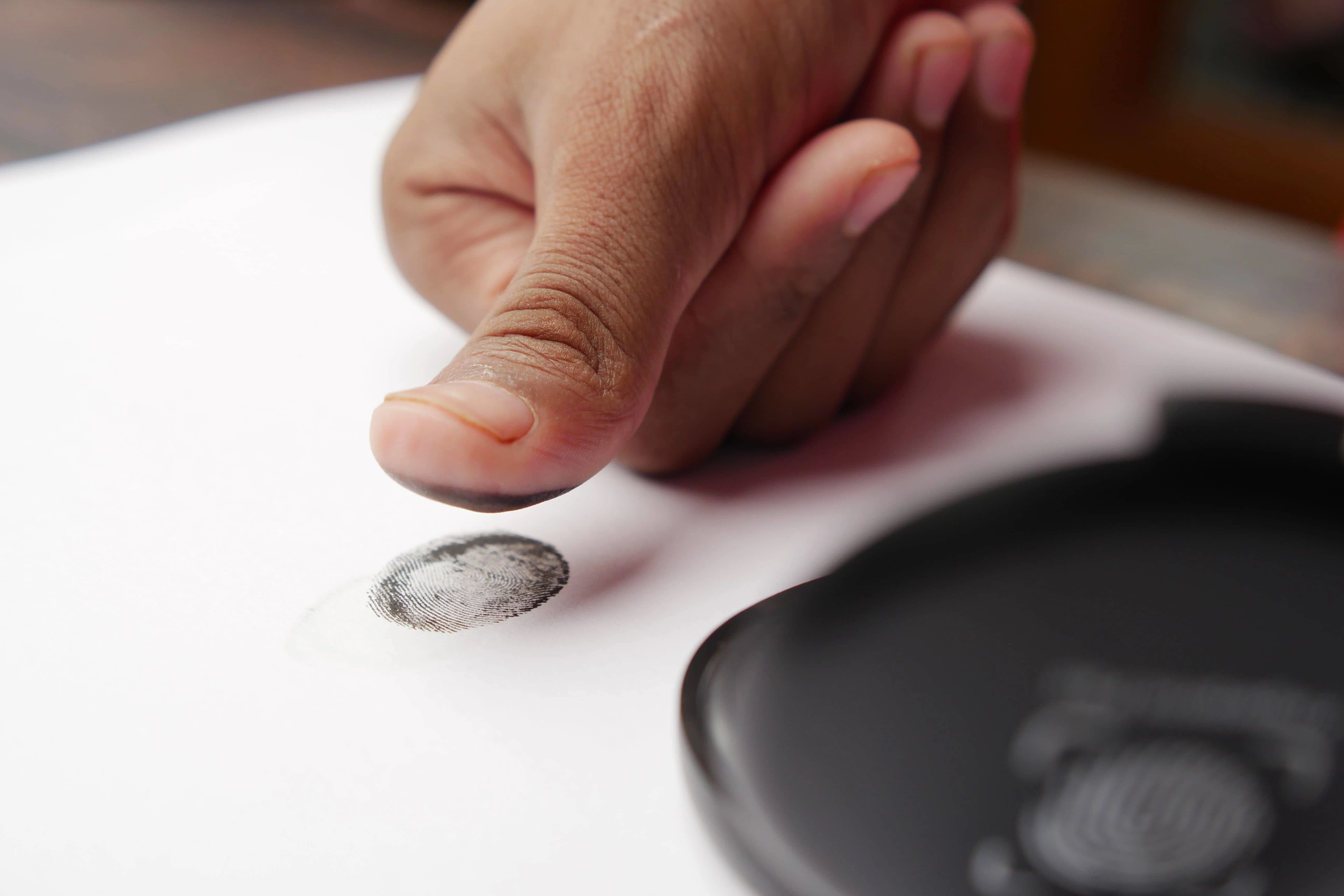 Rolling ink fingerprints by hand at Premier Notary and Fingerprinting in Orlando
